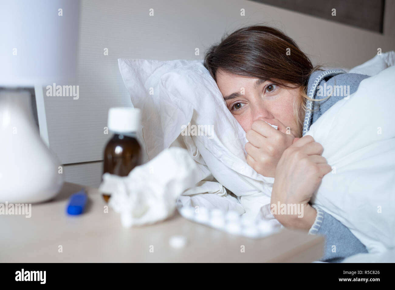 Sad woman feeling cold an flu in bed Stock Photo Alamy