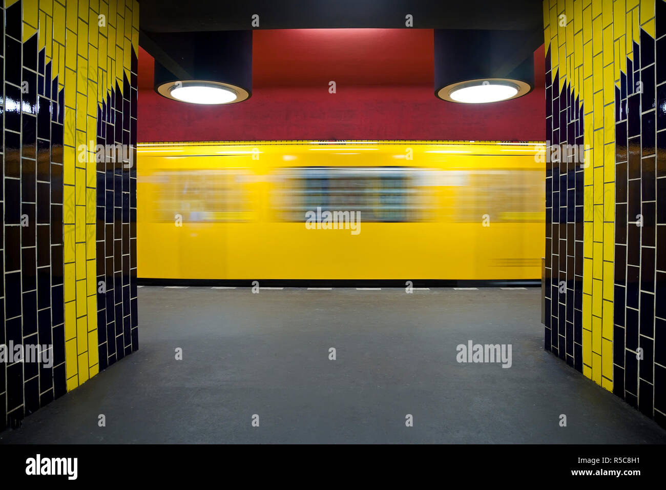 Germany, Berlin, modern subway station, moving train pulling into the station Stock Photo
