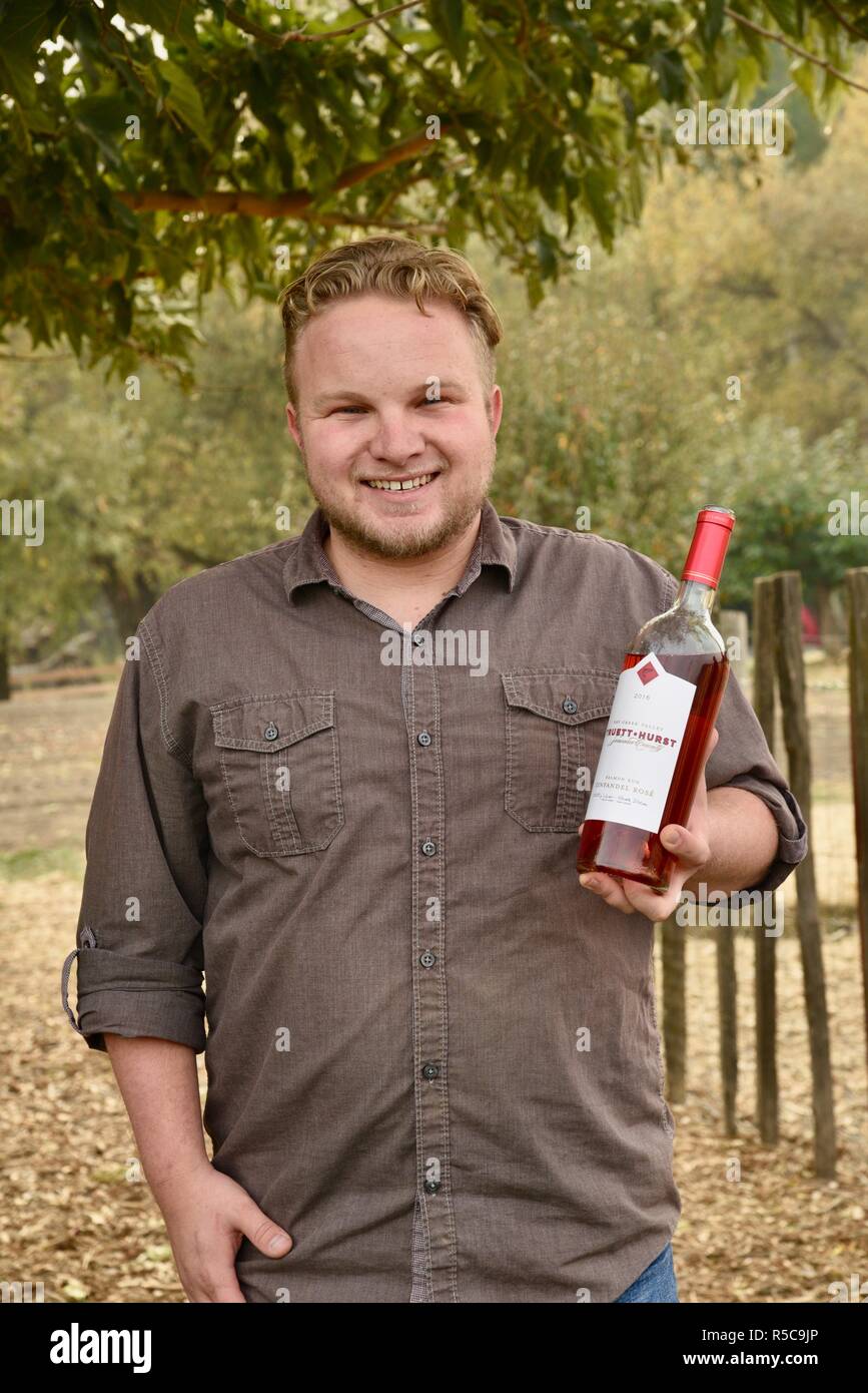 Bearded smiling young man holding wine bottle, sharing samples outside  tasting room at Truett Hurst Winery, Sonoma County, Healdsburg, California,  USA Stock Photo - Alamy