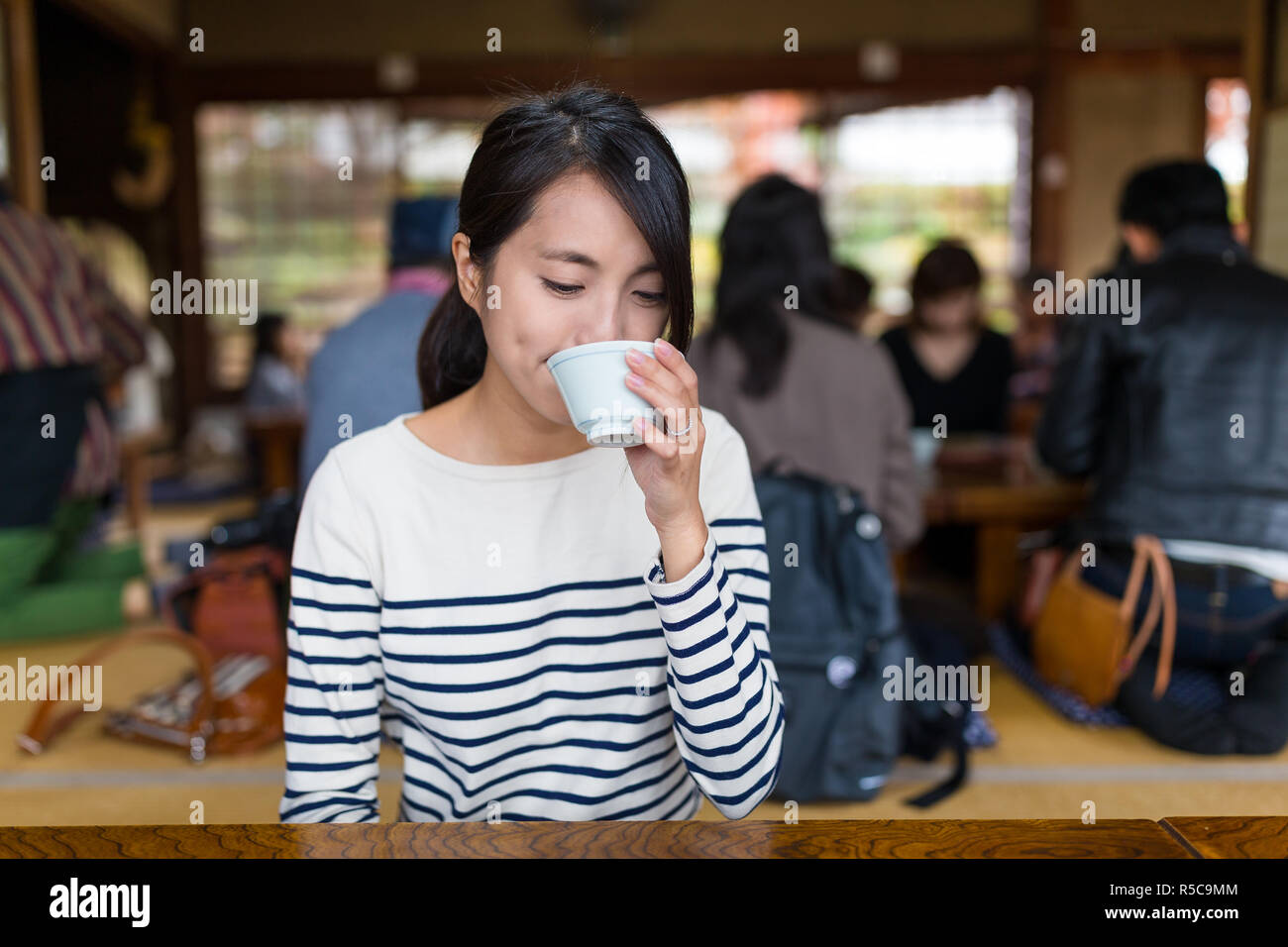 Woman enjoy her drink in japanese restaurant Stock Photo Alamy