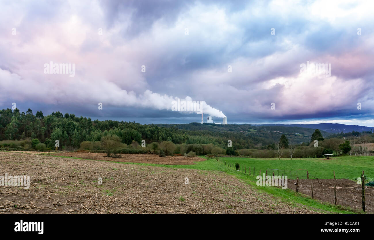 Environmental pollution problem concept. Coal power plant polluting the planet. Thick chimney smoking towards the sky. Meirama coal power plant, Galic Stock Photo