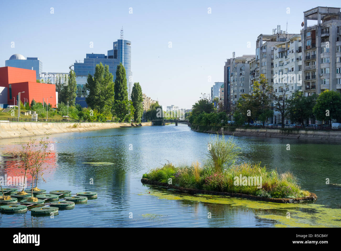 Dambovita river in downtown Bucharest; residential and office buildings on its shoreline, Romania Stock Photo