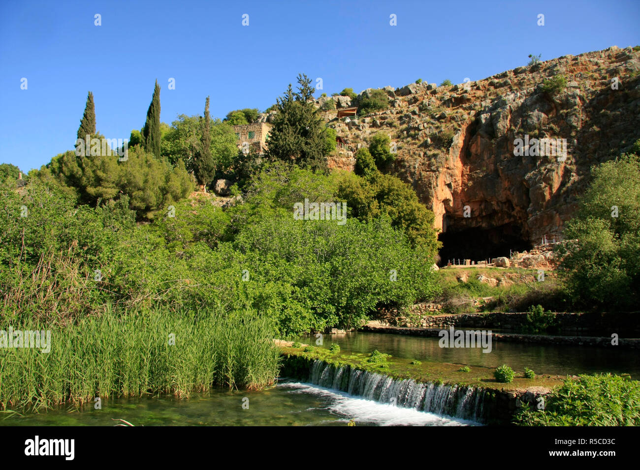 Israel, Golan Heights, the Banias stream, a source of the Jordan River, the Grotto of Pan in the background Stock Photo