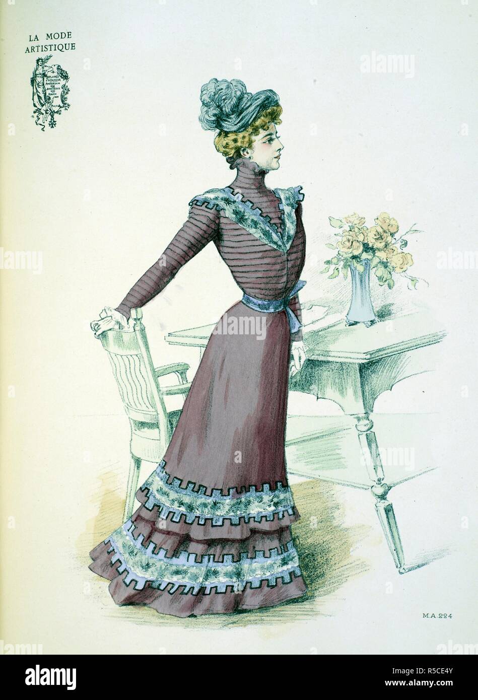 'A visiting dress of mulberry cloth created by Lejeune-Soinard ... The skirt is trimmed with two shaped flounces, nearly flat; in the centre of each is a band of chinchilla, surrounded by a sort of castellated Greek design in mauve velvet edged with black. The corsage and sleeves are entirely comopsed of pleats and we find again upon the bodice the trimming of the skirt in a smaller design. Waistband of the mauve, and toque of grey velvet'. . The Powder Puff [An English edition of 'La Mode artistique'.; 1898]. (London, England : 1898). Source: The Powder Puff Autumn and Winter plate 224. Stock Photo