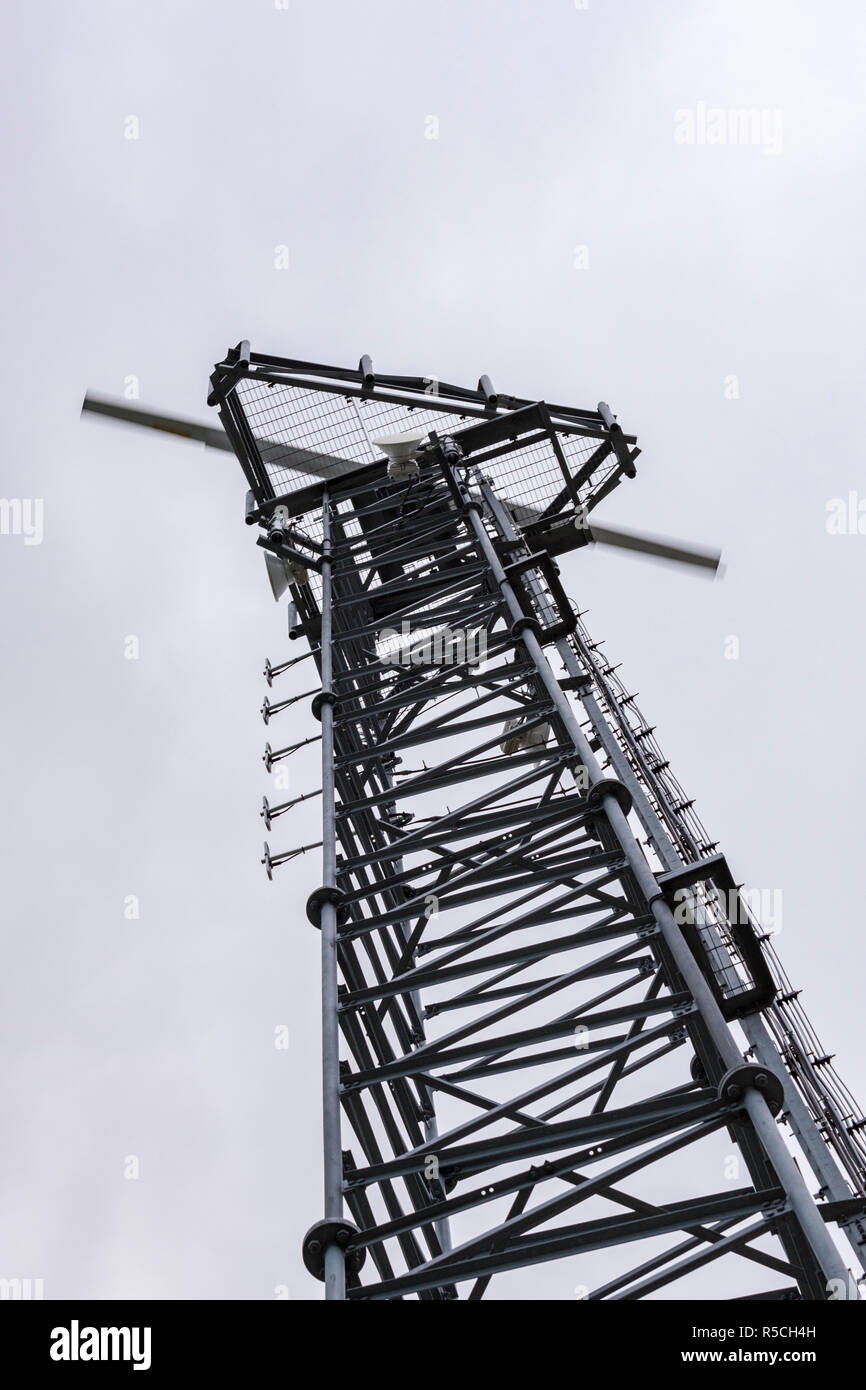 a radio or television transmitter mast with a radar transducer turning on the top. Stock Photo