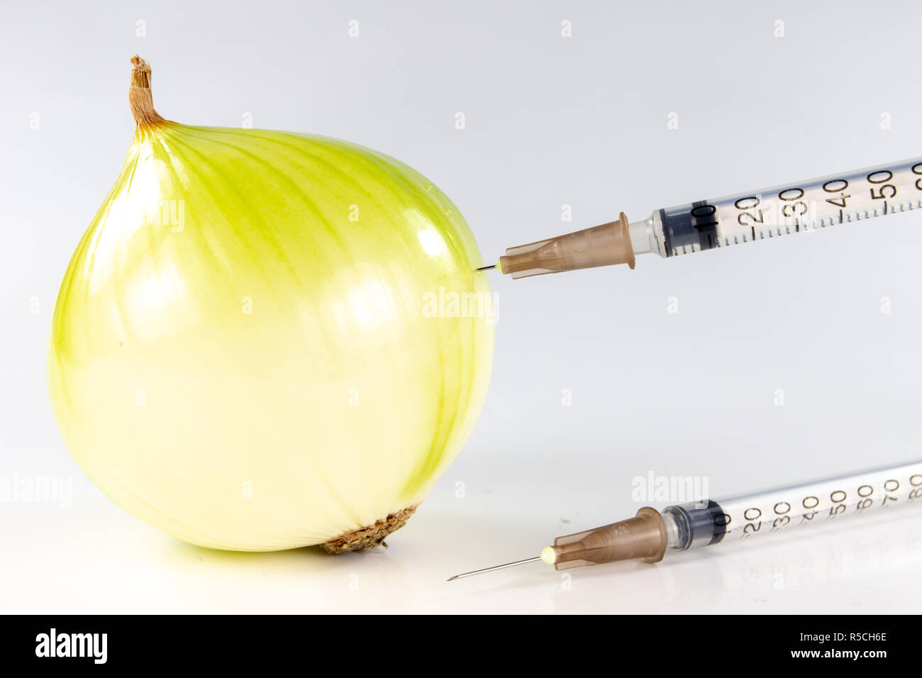 Healthy onion juice for colds. Natural medicine irreplaceable in the home medicine cabinet. White background. Stock Photo