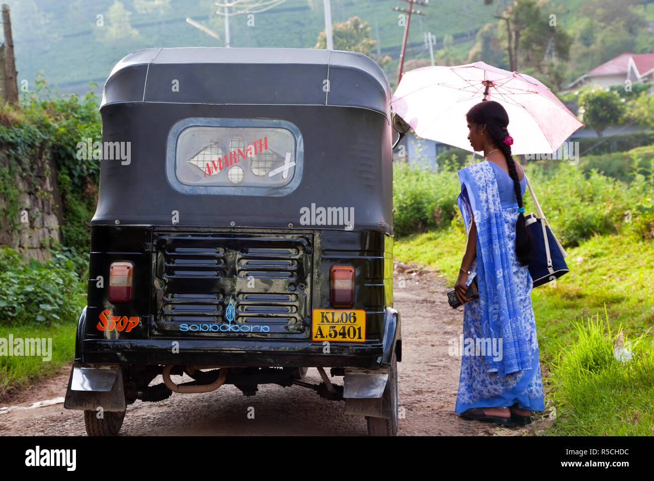Woman & auto rickshaw, Munnar, Kerala, India Stock Photo
