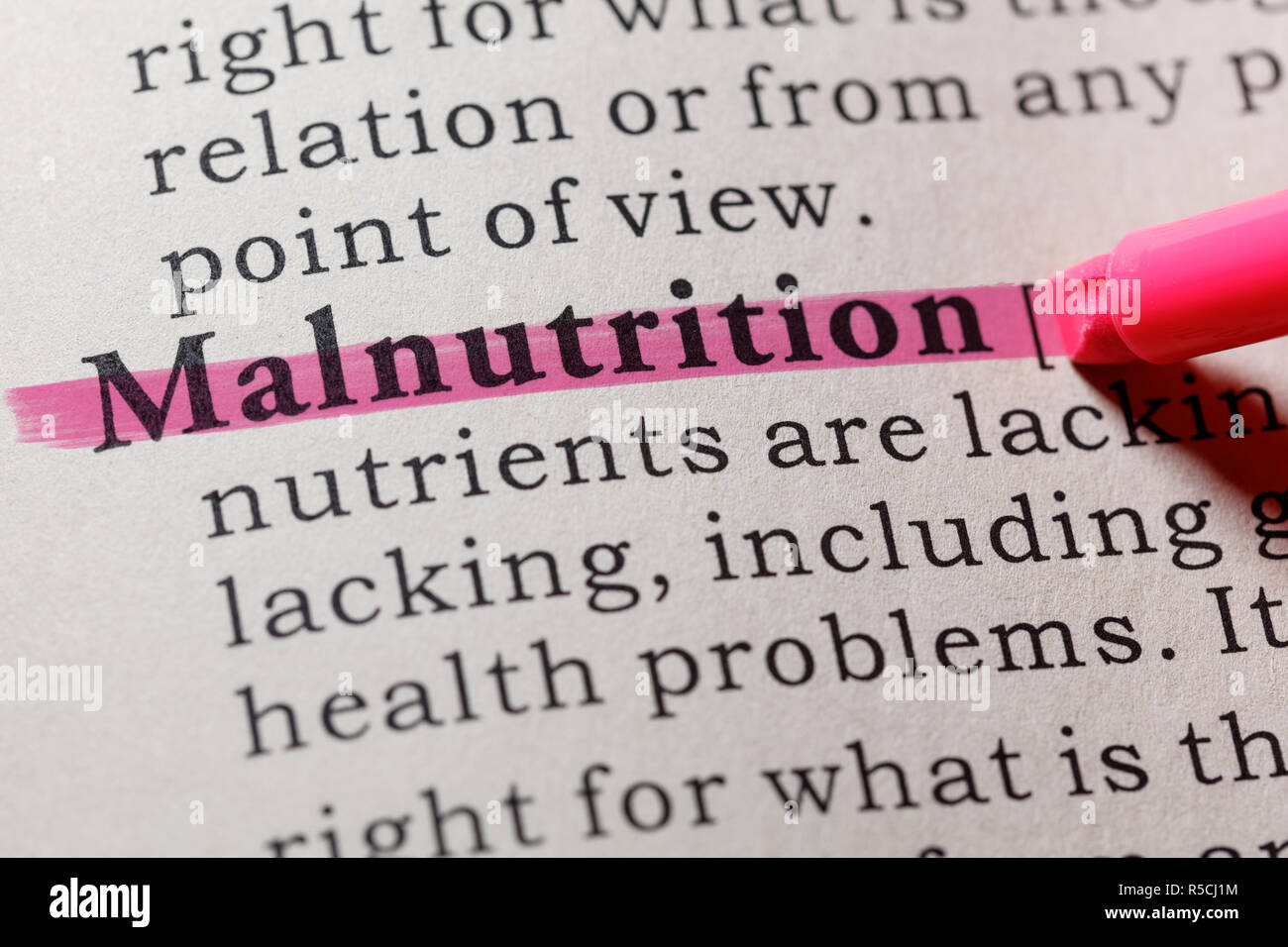 Fake Dictionary, Dictionary definition of the word malnutrition. including key descriptive words. Stock Photo