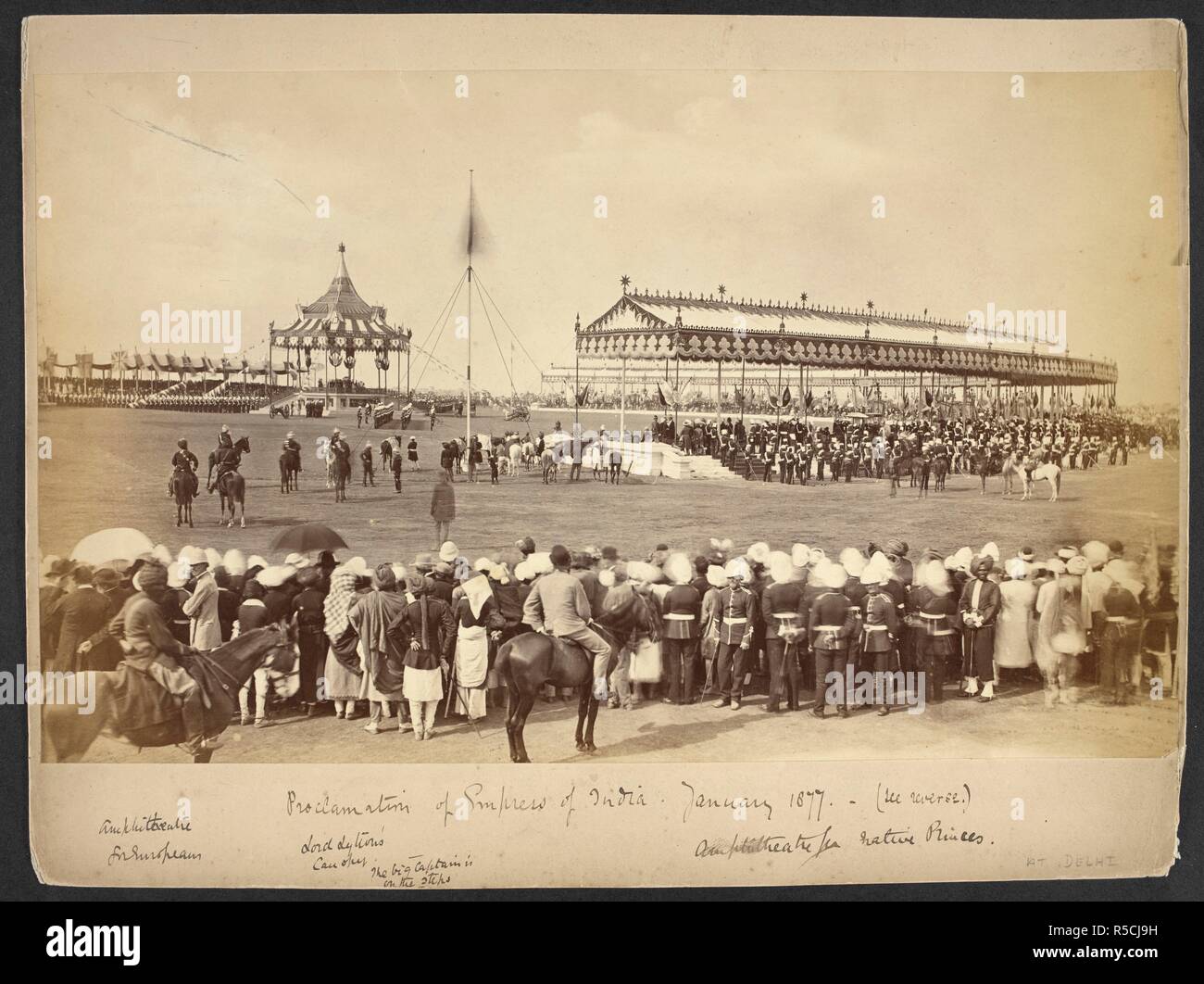 Proclamation of Empress of India, January 1877. General view of the assemblage with crowds of spectators in the foreground. Contemporary notes on the mount beneath the print identify the amphitheatre for Europeans (left), Lord Lytton's canopy (centre: the Viceroy can just be made out seated beneath the canopy), and the amphitheatre for native princes (right). 1 Jan 1877. photograph. Source: Photo 4/(1). Language: English. Author: BOURNE AND SHEPHERD. Stock Photo