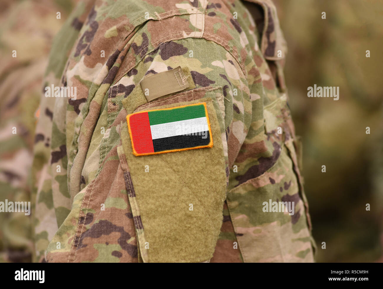 Flag of United Arab Emirates (UAE) on soldiers arm (collage). Stock Photo