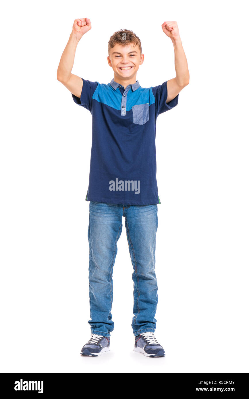 Full length portrait of young caucasian teen boy isolated on white background. Victory screaming funny teenager. Handsome winner child with his hands  Stock Photo