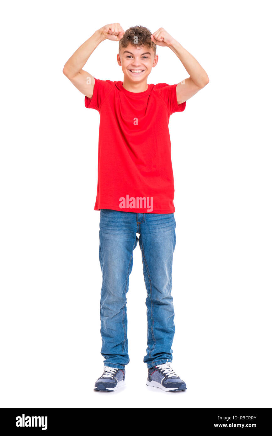 Full length portrait of young caucasian teen boy isolated on white background. Victory screaming funny teenager. Handsome winner child with his hands  Stock Photo