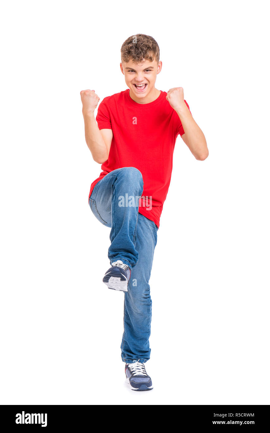 Full length portrait of young caucasian teen boy isolated on white background. Victory screaming funny teenager. Handsome winner child looking at came Stock Photo