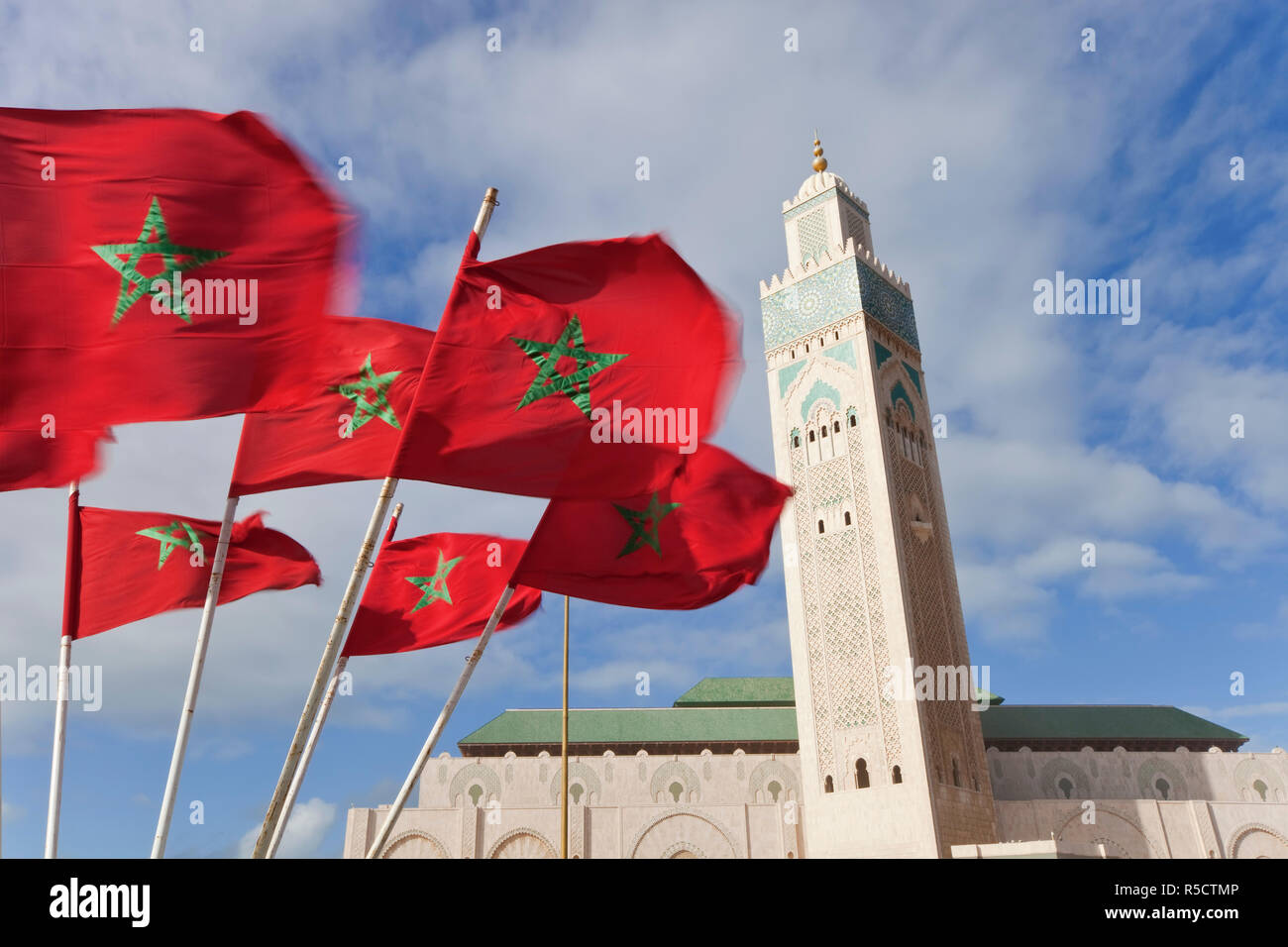 Flags of Morocco waving in the wind and Hassan II Mosque, the third largest mosque in the world, Casablanca, Morocco, North Africa Stock Photo