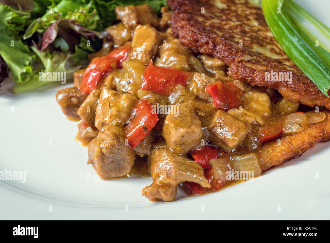 hungarian goulash with potato pancakes Stock Photo Alamy