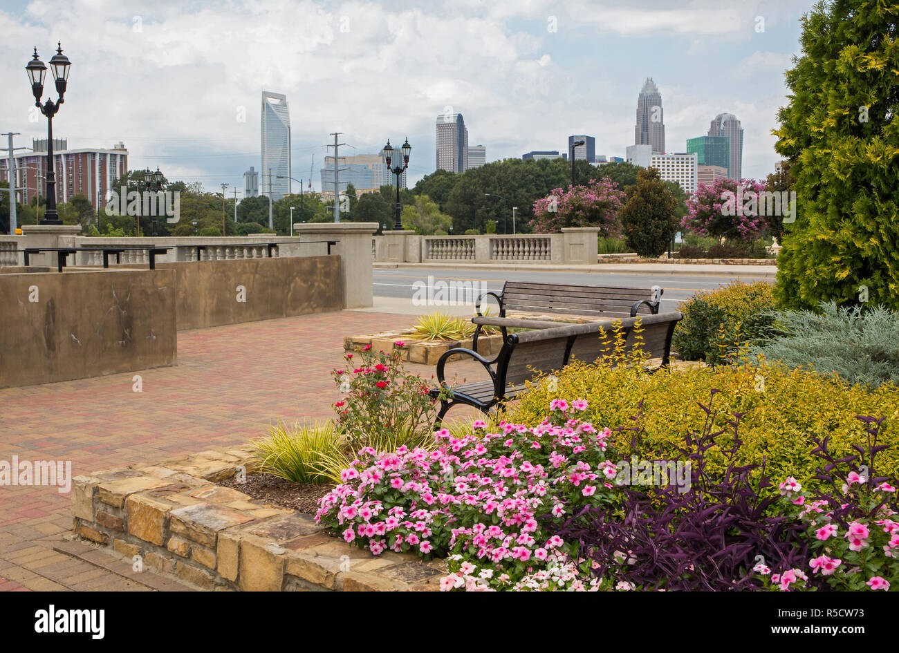 Urban greenway with park benches and flowers near downtown Charlotte, North Carolina. Stock Photo