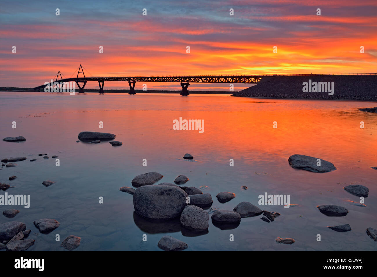 Sunrise over the MacKenzie River with the Deh Cho Bridge, Fort Providence, Northwest Territories, Canada Stock Photo