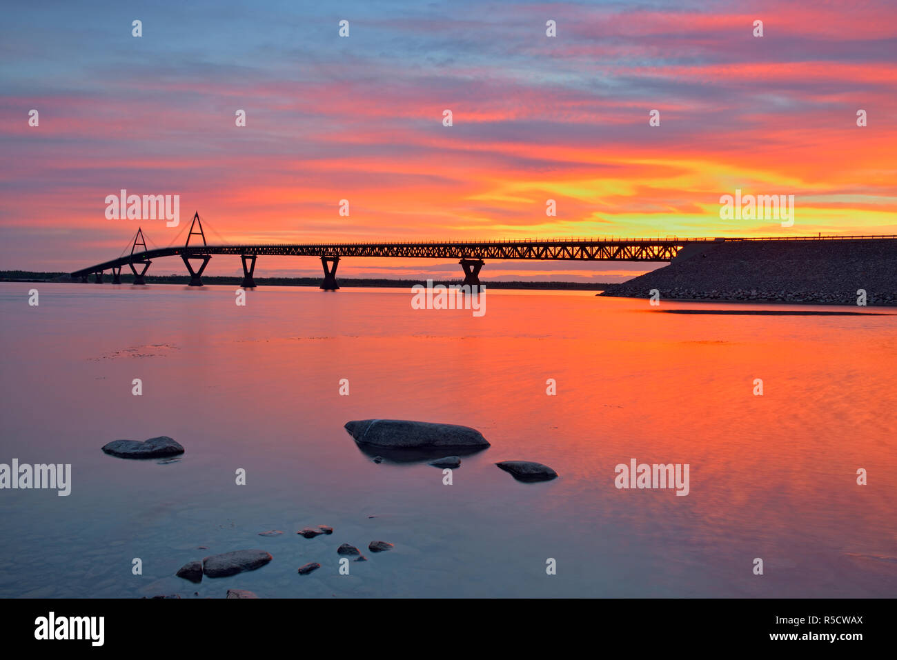 Sunrise over the MacKenzie River with the Deh Cho Bridge, Fort Providence, Northwest Territories, Canada Stock Photo