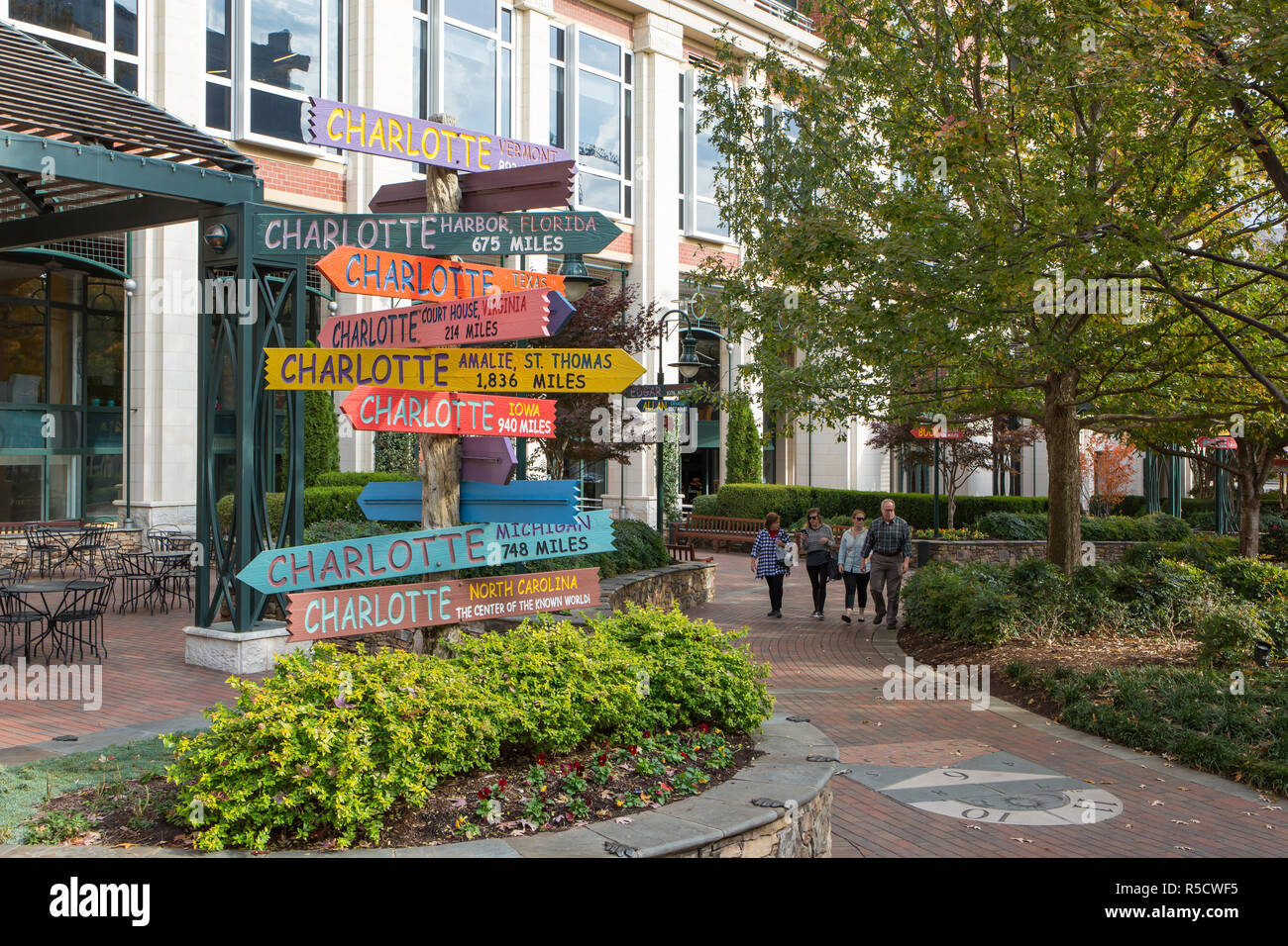 CHARLOTTE, NC - November 25, 2016:  Humorous directional signs along a path in The Green, an urban park in uptown Charlotte, North Carolina. Stock Photo