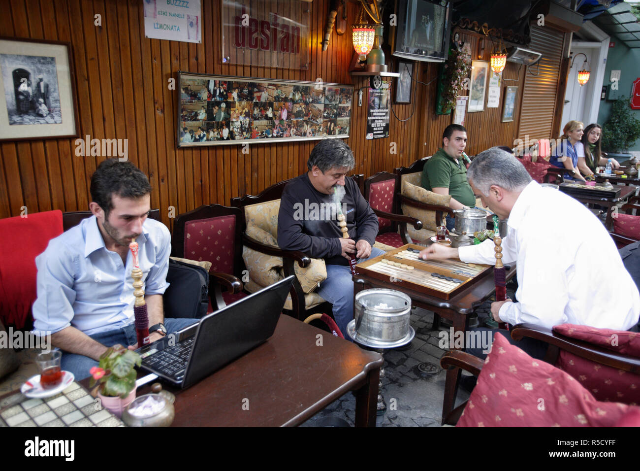 Old and New Traditions. Customers at Destan Nargileh & Cafe, Ortakcoy district, Istanbul, Turkey Stock Photo