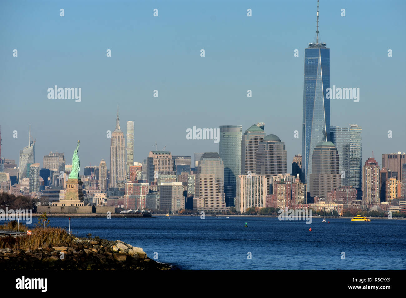 A view of three of New York City's landmarks from across the Hudson River; the Statue of Liberty, the  Empire State Building, and the Freedom Tower. Stock Photo