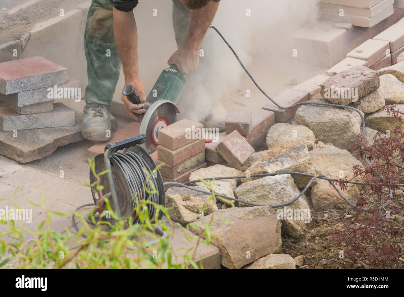 craftsman works with an electric grinder Stock Photo Alamy