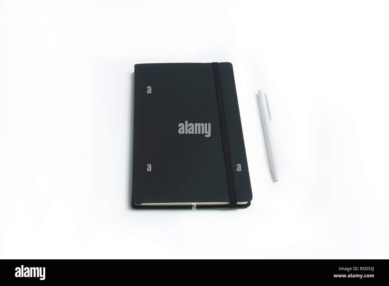 Notebook and white pen isolated on white background Stock Photo - Alamy