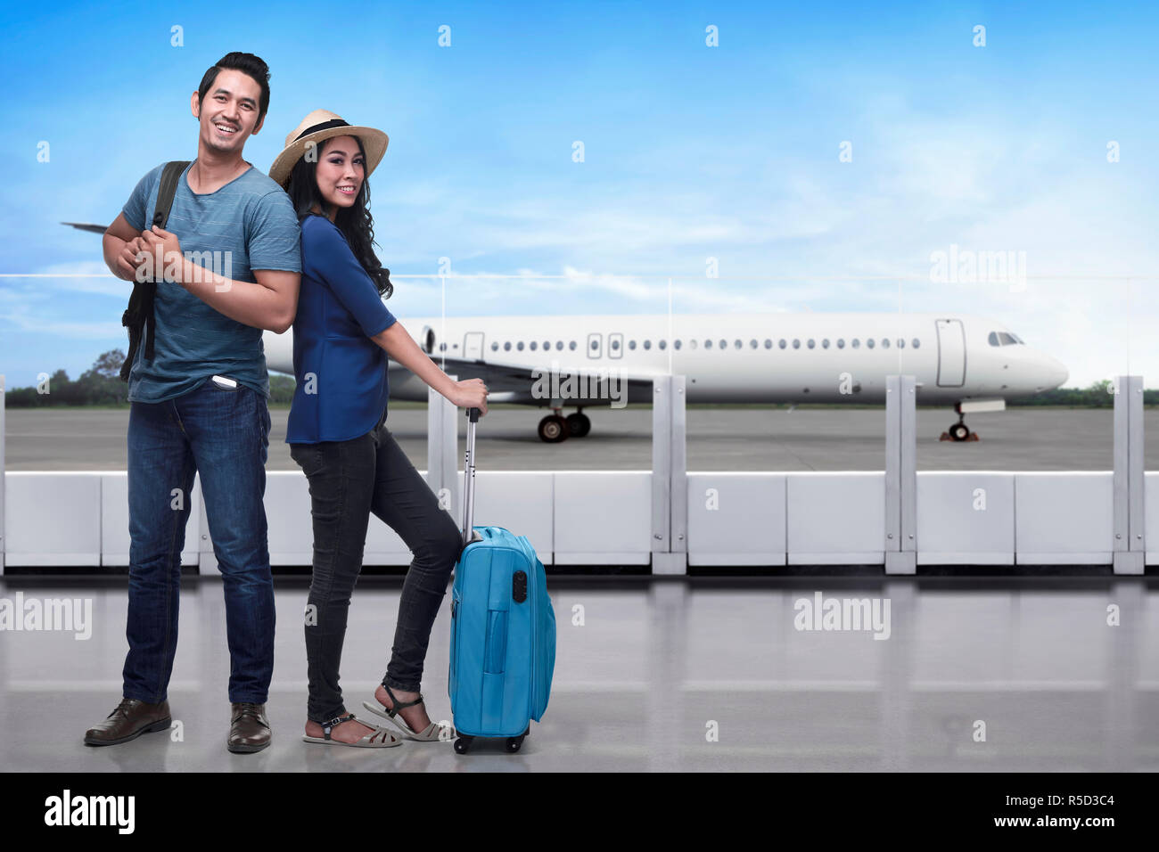 Portrait of asian tourist couple with backpack and suitcase standing Stock Photo