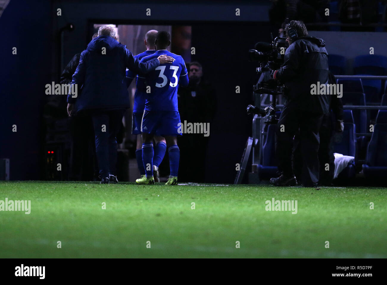 Cardiff city's goal scorers Aron Gunnarsson and Junior Hoilett (33) walk off the pitch and down the tunnel at the end of the game.Premier League match, Cardiff City v Wolverhampton Wanderers at the Cardiff City Stadium on Friday 30th November 2018.  this image may only be used for Editorial purposes. Editorial use only, license required for commercial use. No use in betting, games or a single club/league/player publications. pic by  Andrew Orchard/Andrew Orchard sports photography/Alamy Live news Stock Photo