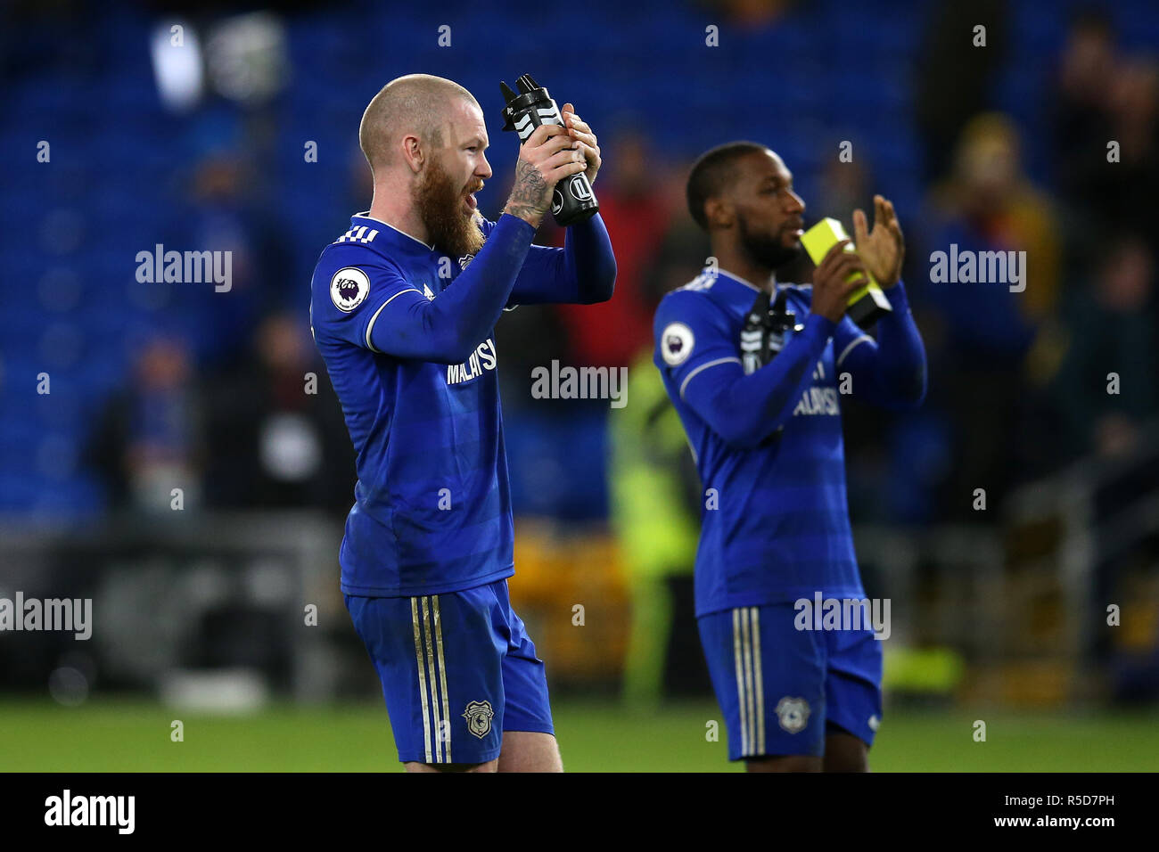 Cardiff city's goal scorers Aron Gunnarsson (l) and Junior Hoilett applaud the fans at the end of the game. Premier League match, Cardiff City v Wolverhampton Wanderers at the Cardiff City Stadium on Friday 30th November 2018.  this image may only be used for Editorial purposes. Editorial use only, license required for commercial use. No use in betting, games or a single club/league/player publications. pic by  Andrew Orchard/Andrew Orchard sports photography/Alamy Live news Stock Photo