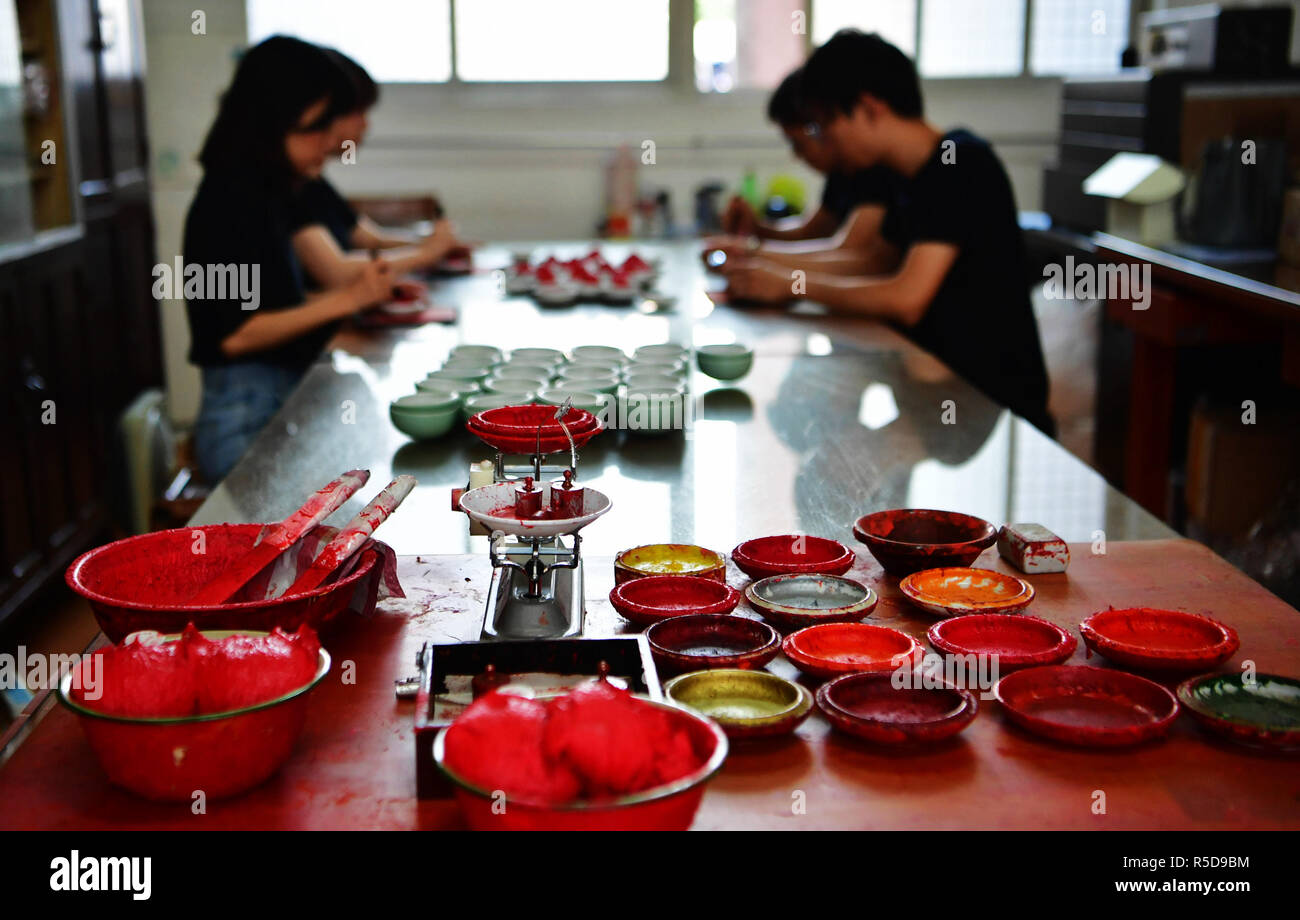 Zhangzhou, China's Fujian Province. 30th Nov, 2018. Workers fill Babao red ink paste into saucers in Zhangzhou, southeast China's Fujian Province, Nov. 30, 2018. Made of many precious materials such as pearl, agate, coral and musk, Zhangzhou red ink paste has been favoured by painters and calligraphers both home and abroad for over 300 years. Its making technology was listed as the second batch of national intangible cultural heritages in 2008. Credit: Wei Peiquan/Xinhua/Alamy Live News Stock Photo