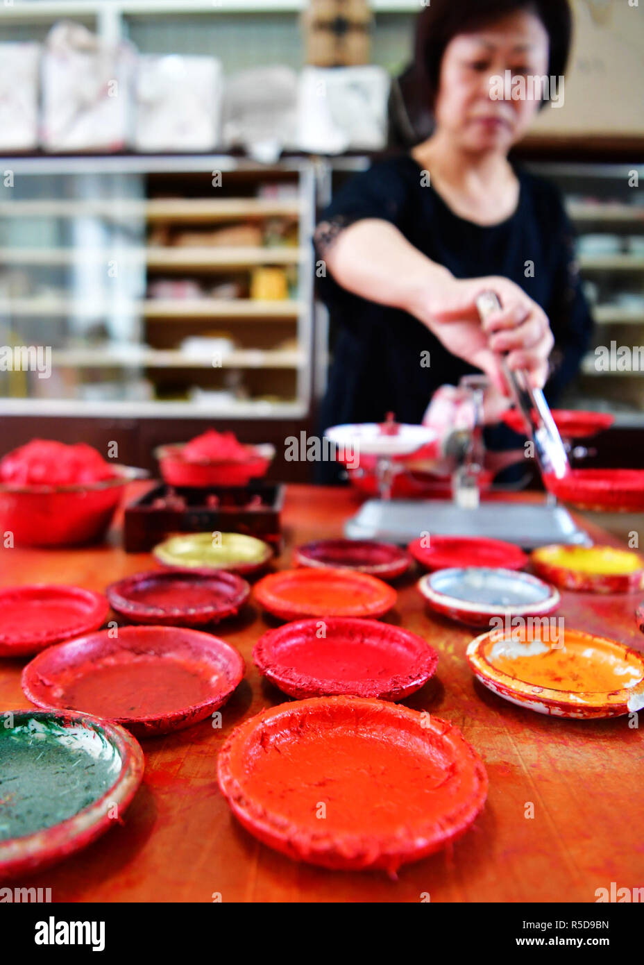 Zhangzhou, China's Fujian Province. 30th Nov, 2018. A worker weighs the Babao red ink paste in Zhangzhou, southeast China's Fujian Province, Nov. 30, 2018. Made of many precious materials such as pearl, agate, coral and musk, Zhangzhou red ink paste has been favoured by painters and calligraphers both home and abroad for over 300 years. Its making technology was listed as the second batch of national intangible cultural heritages in 2008. Credit: Wei Peiquan/Xinhua/Alamy Live News Stock Photo
