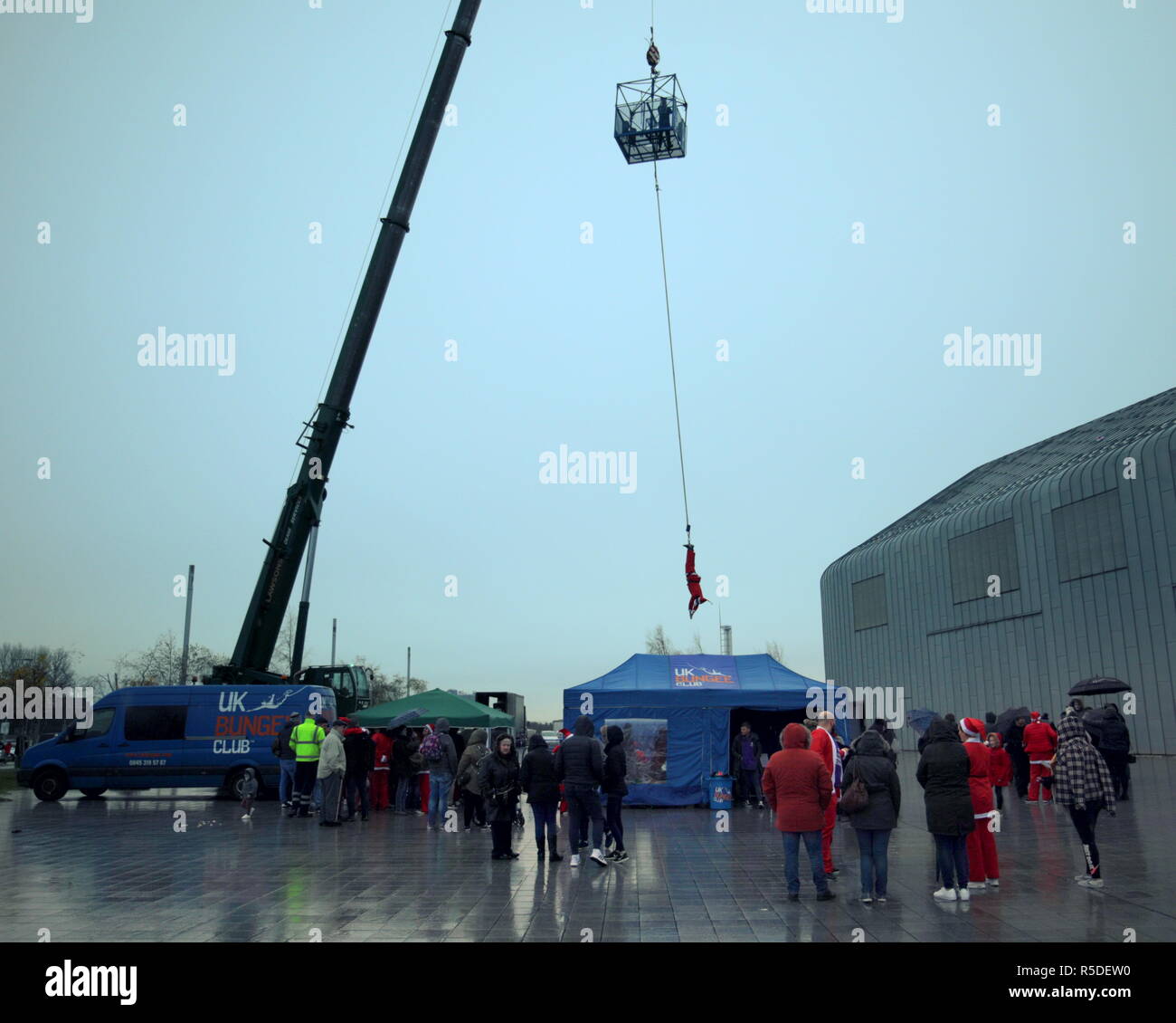 Glasgow, Scotland, UK 1st December, 2018. The annual Riverside Christmas Festival in the  famous city Riverside  transport museum today as well as its markets inside and fairground attractions outside had Christmas Santas aleaping for charity as people bungee jumped in costume for various charities with the uk Bungee club.  Gerard Ferry/Alamy news Credit: gerard ferry/Alamy Live News Stock Photo