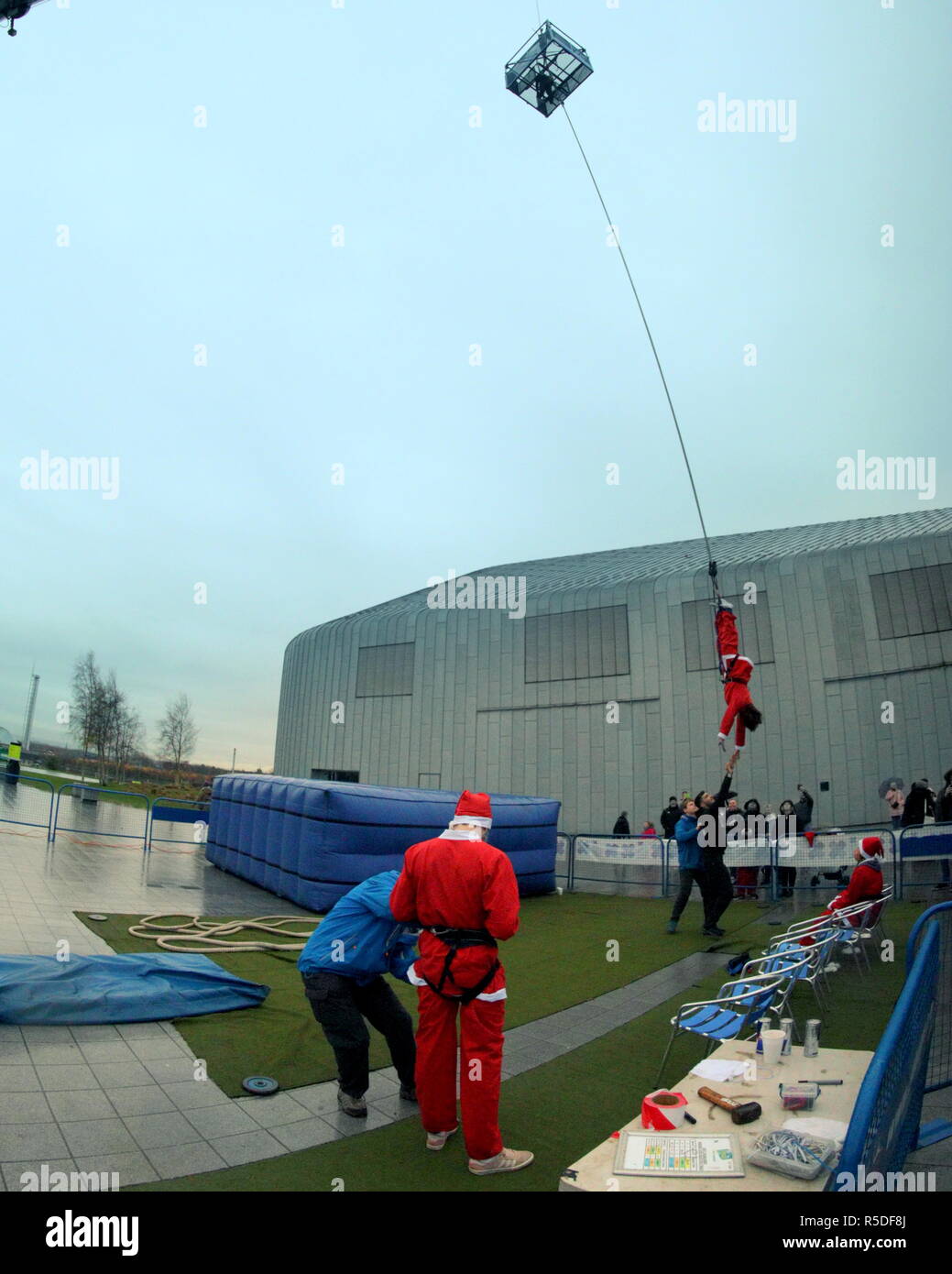Glasgow, Scotland, UK 1st December, 2018. The annual Riverside Christmas Festival in the  famous city Riverside  transport museum today as well as its markets inside and fairground attractions outside had Christmas Santas aleaping for charity as people bungee jumped in costume for various charities with the uk Bungee club.  Gerard Ferry/Alamy news Credit: gerard ferry/Alamy Live News Stock Photo