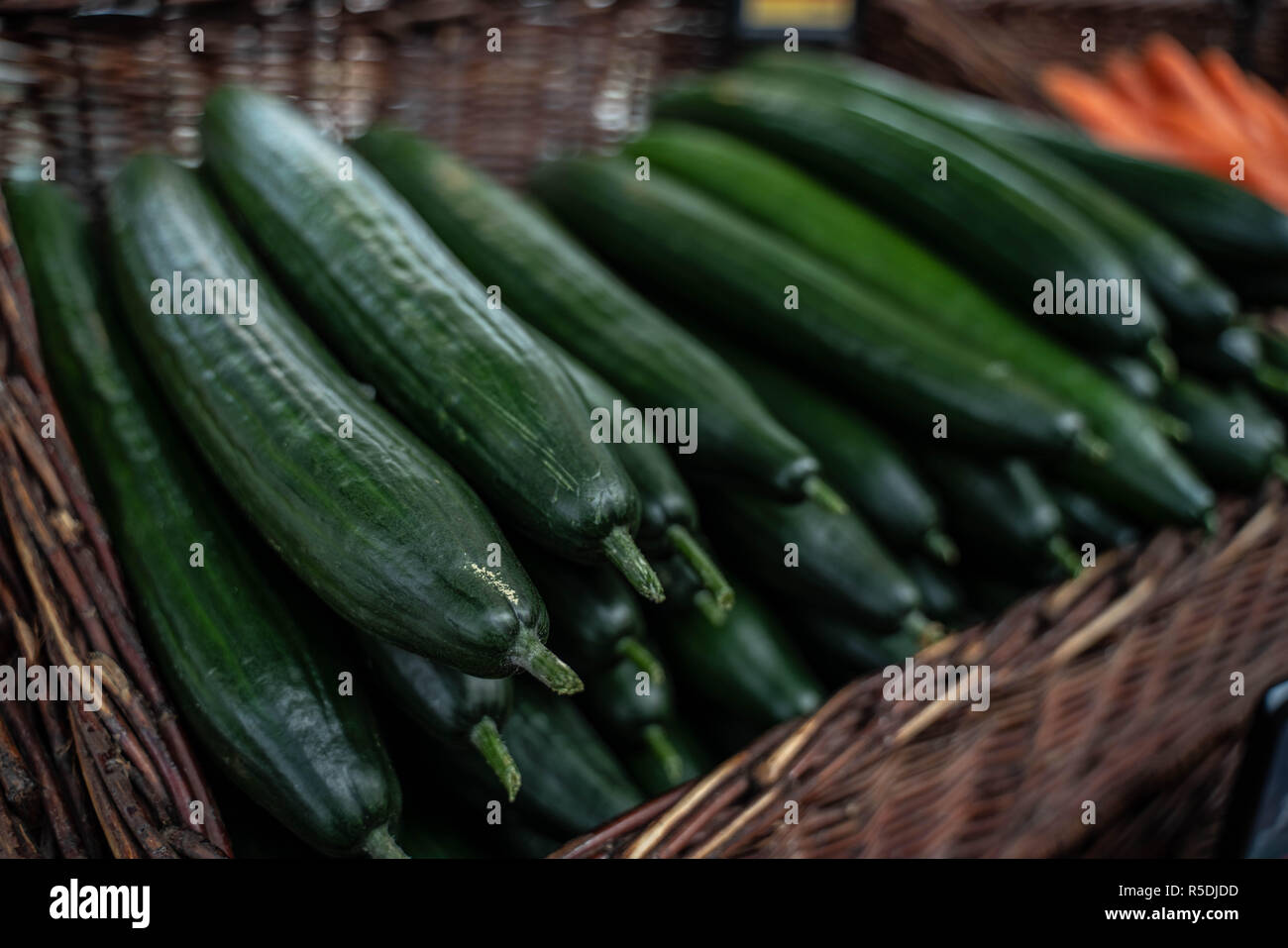 fresh green cucumbers in a wicker net Stock Photo