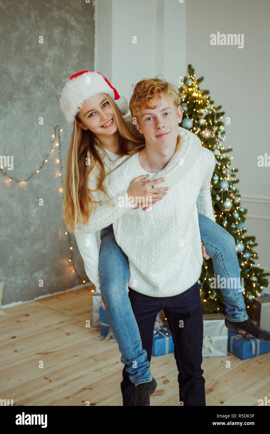 Happy young couple having fun and smiling at camera at christmastime Stock Photo