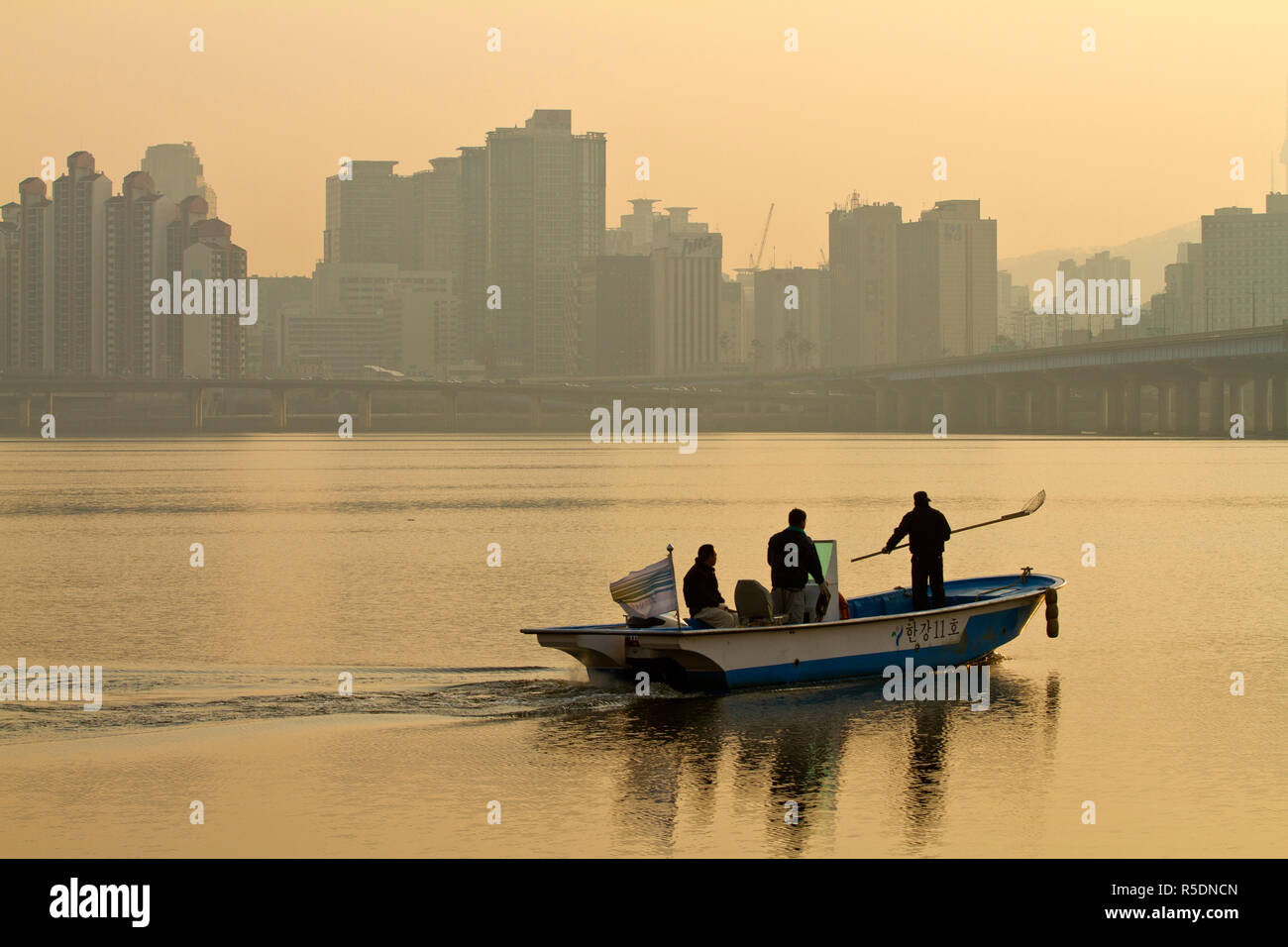 Korea, Seoul, Yeouido, Hangang Riverside Park, Boat on Hangang river at dawn Stock Photo