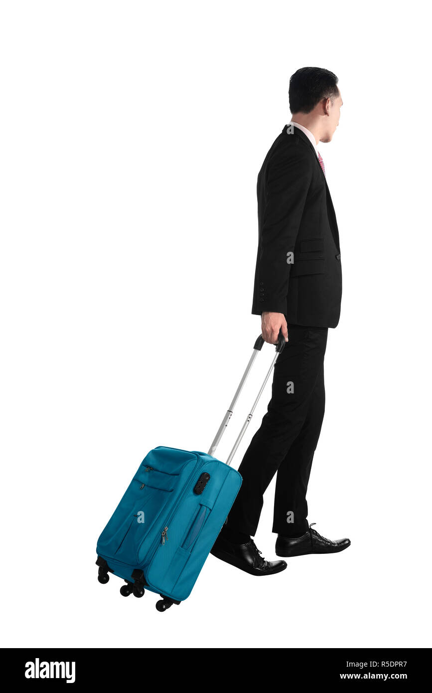 Back view of business man walking with suitcase Stock Photo