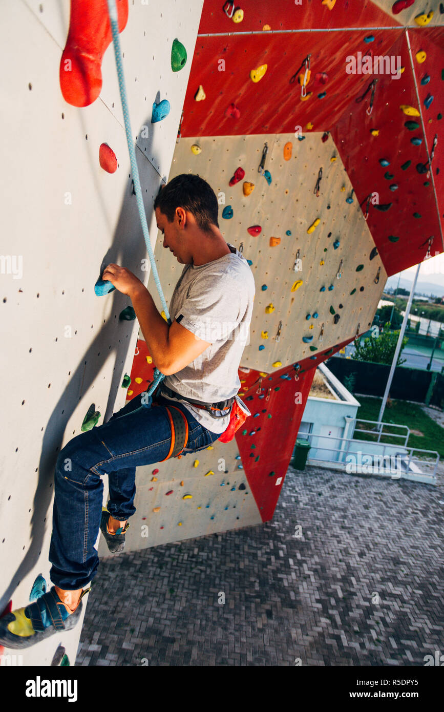 Handsome young man bouldering or rock climbing outdoors Stock Photo Alamy