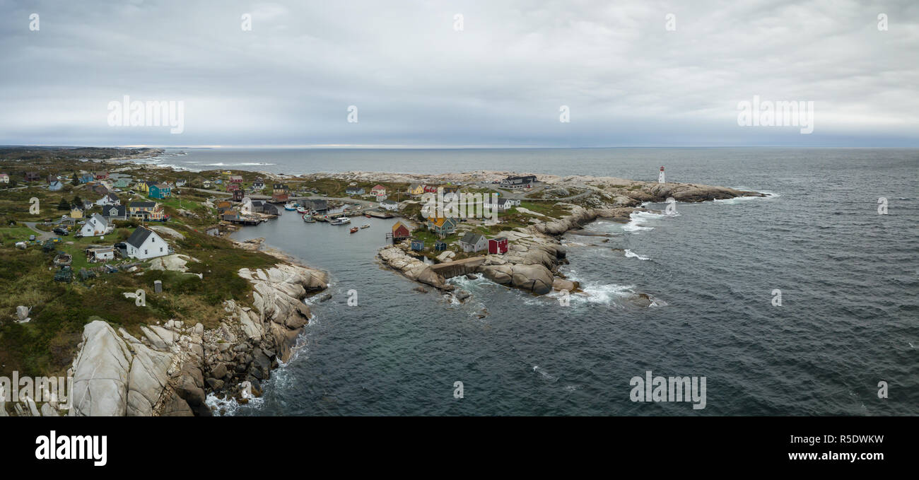 Aerial panoramic view of a small town near a rocky coast on the Atlantic Ocean. Taken in Peggy Cove, near Halifax, Nova Scotia, Canada. Stock Photo