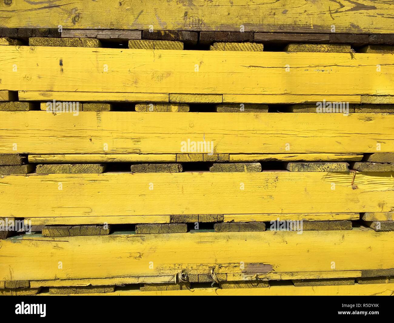 yellow wooden pallets for the transport in close-up Stock Photo