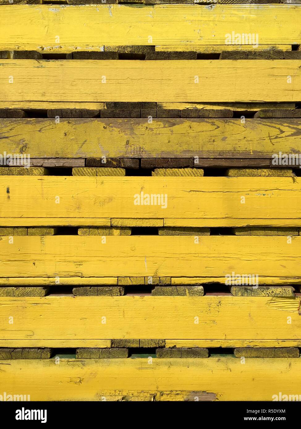 yellow wooden pallets for the transport in close-up Stock Photo