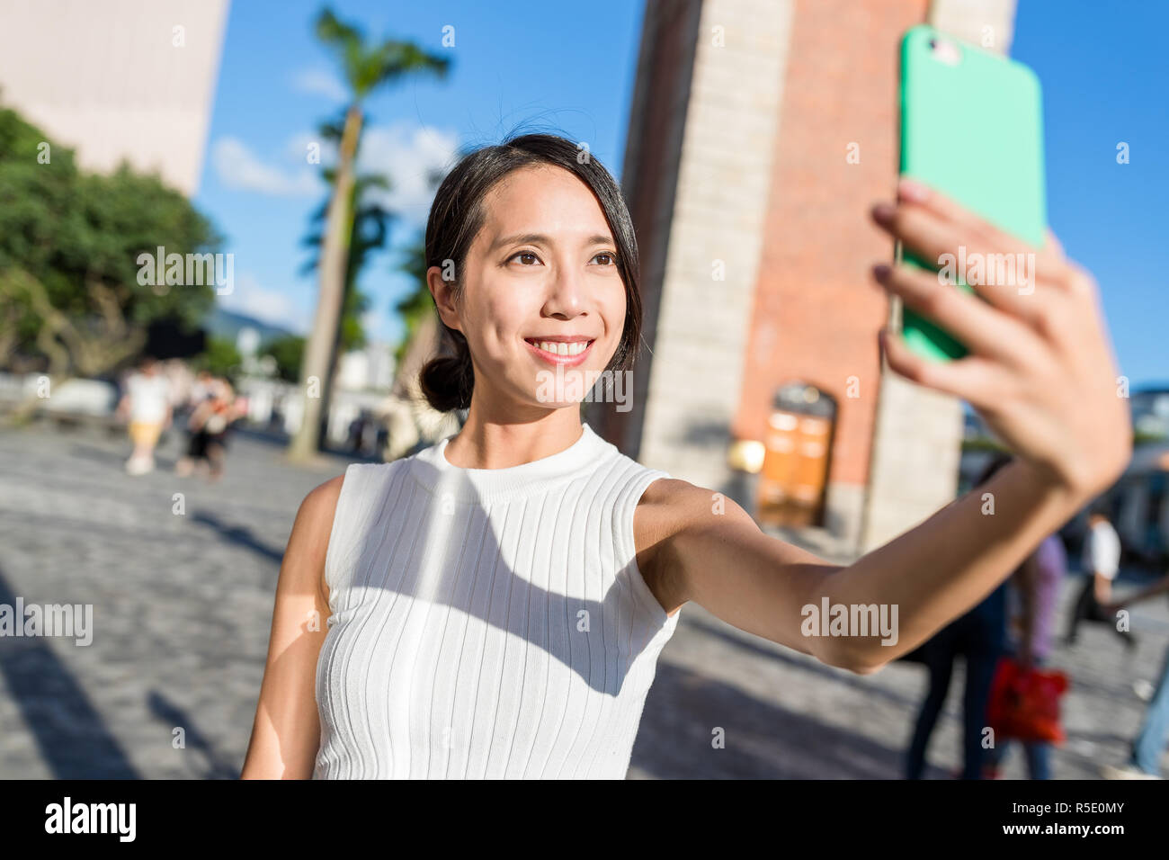 Young woman taking selfie with mobile phone in Hong Kong Stock Photo ...