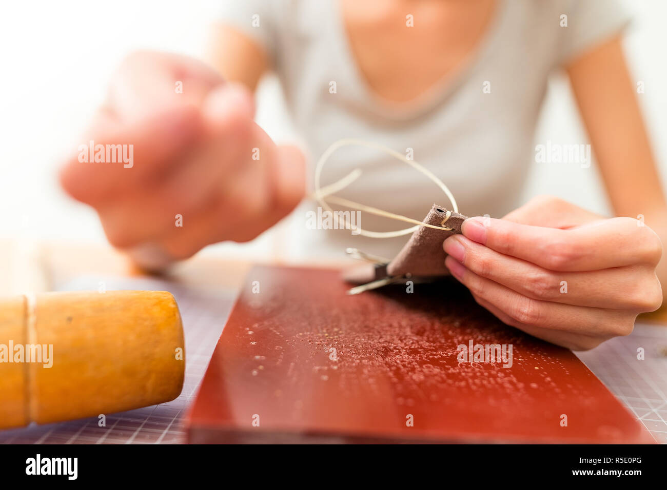 Leather handbag craftsman at work in a workshop Stock Photo