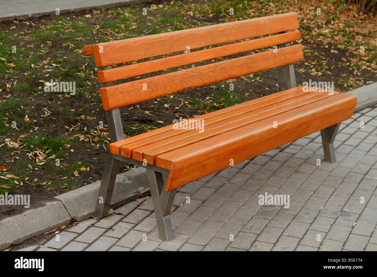 Empty brown bench in the autumn park. Stock Photo