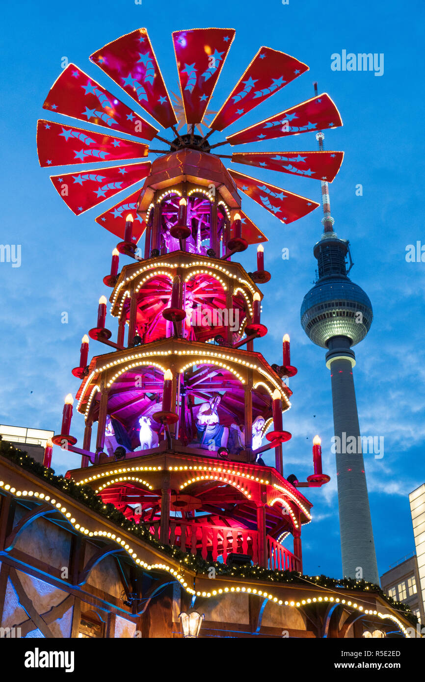 Traditional Christmas Market at Alexanderplatz in Mitte, Berlin, Germany. Pictured the Pyramiden Treff or Pyramid meeting place and Fersehturm, the te Stock Photo