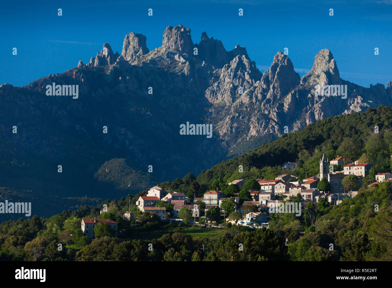 France, Corsica, Corse-du-Sud Department, La Alta Rocca Region, Zonza, elevated town view with the Aiguilles de Bavella peaks Stock Photo