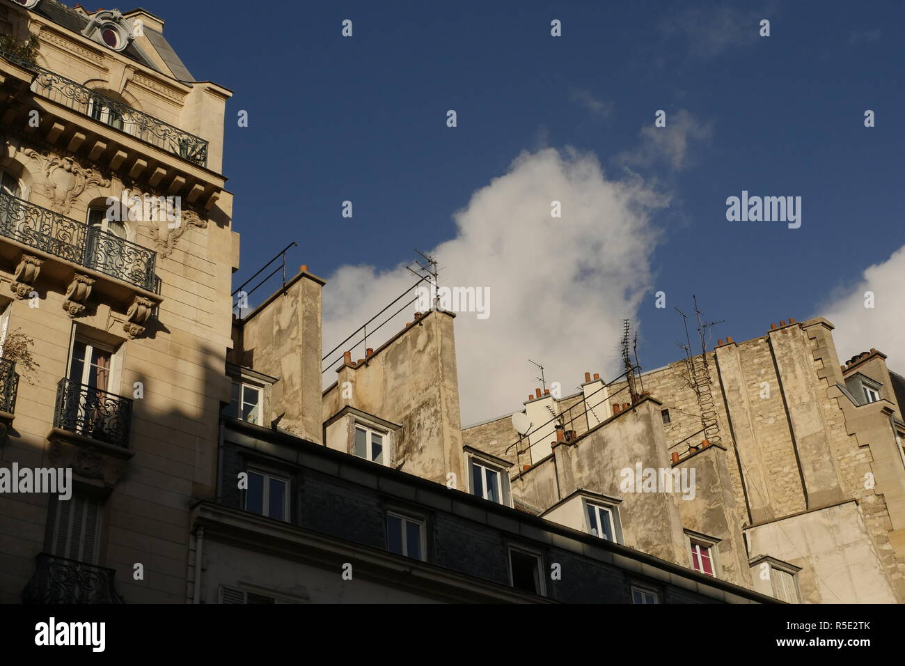 Rooftops and windows of Paris. A view of rooftops and windows shining in the Parisienne sun. Stock Photo