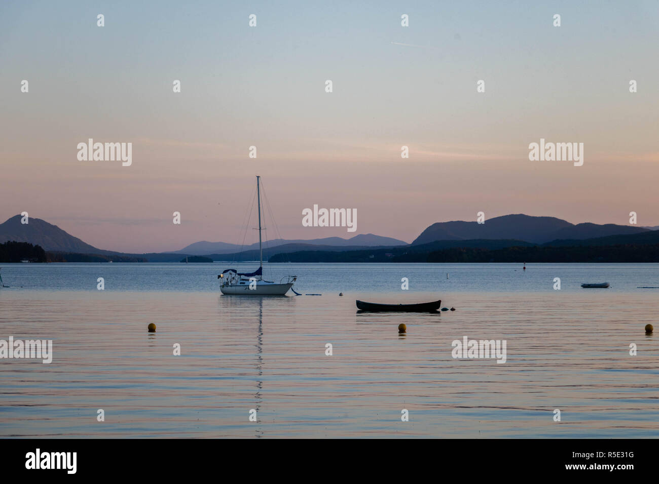 Two boats at the Magog Lake at sunset. The town of Magog, Quebec, Canada. Stock Photo