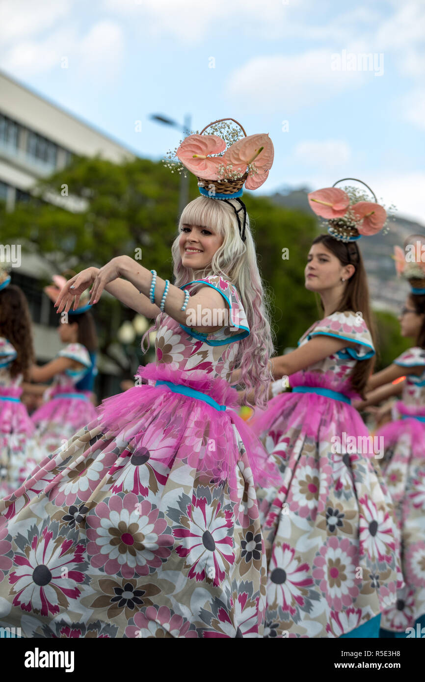 Funchal; Madeira; Portugal - April 22; 2018: A group of girls in colorful costumes are dancing at Madeira Flower Festival Parade in Funchal on the Isl Stock Photo